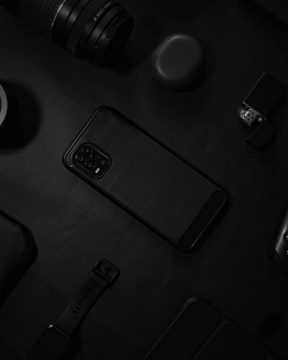 an iphone and other electronics all lined up on a black surface