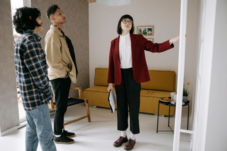 three people are standing in the living room