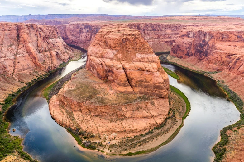 the river runs through a mountainous landscape with rock formations and cliffs