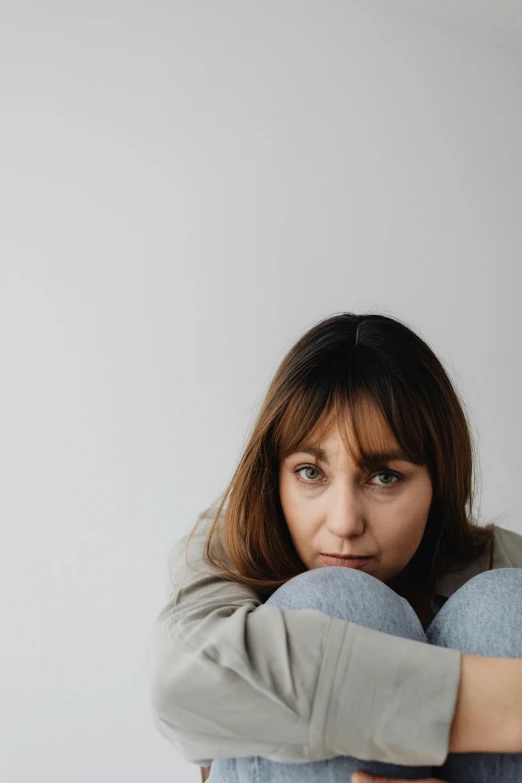 a woman holding her hands in her face