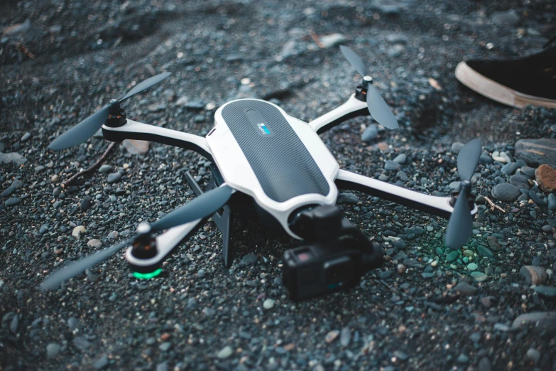 a white and gray remote controlled aerial vehicle with camera