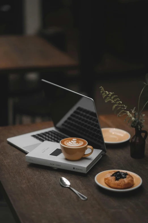 a laptop and plate on top of a table