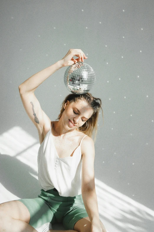 a woman in short shorts holding up a silver bowl