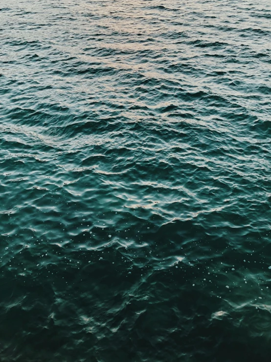 a couple of small boats floating on top of the ocean