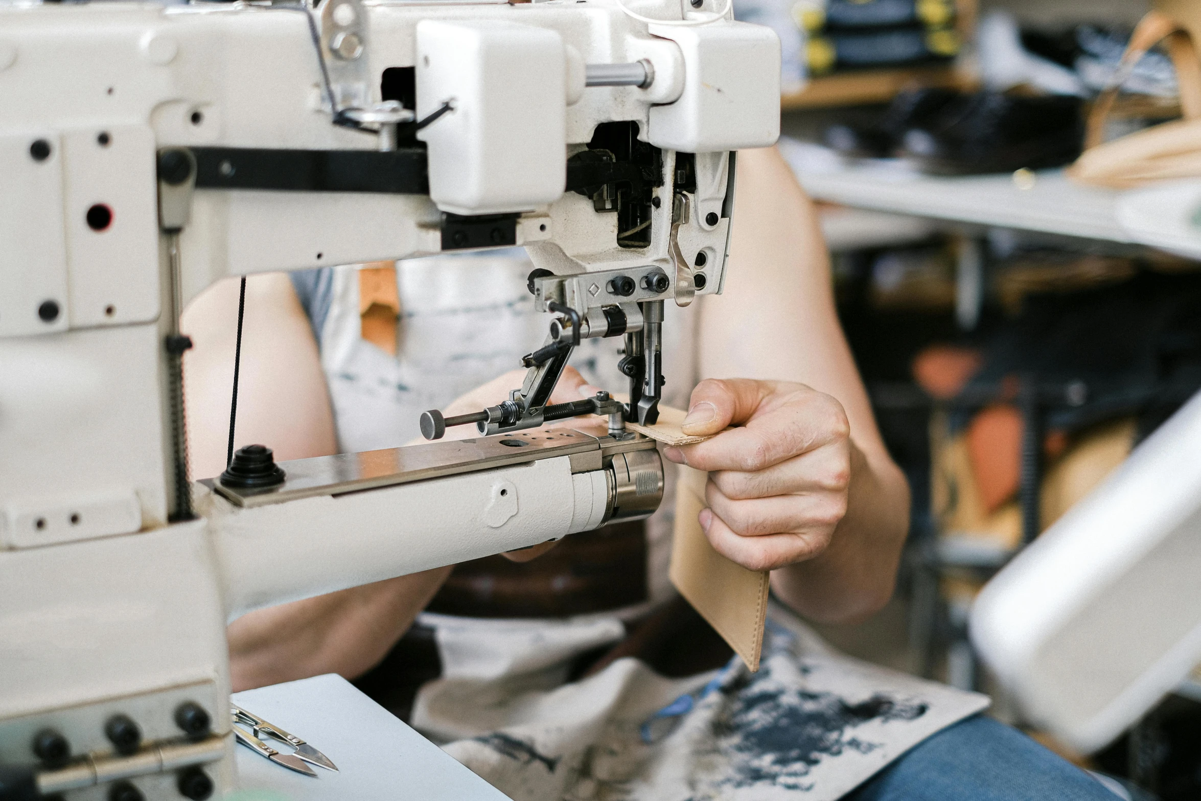 a man is sitting at a machine working on soing