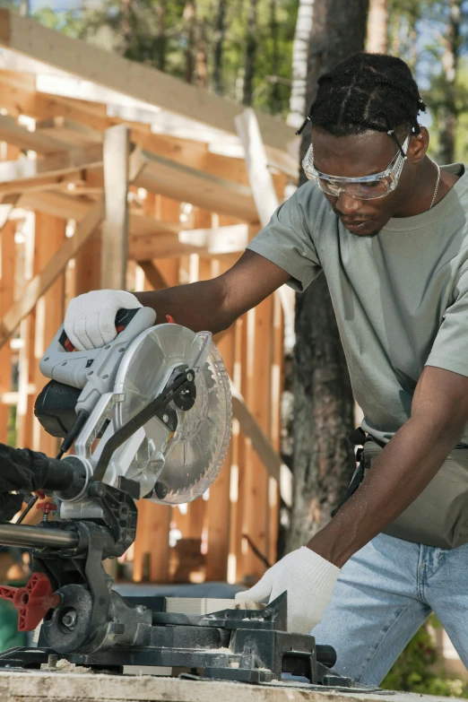 a man working on a machine with wood frame