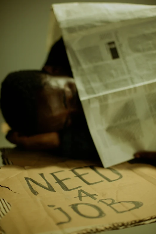 a young person lies with his head on a box