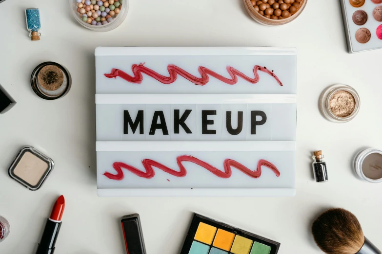 a makeup sign surrounded by various beauty products