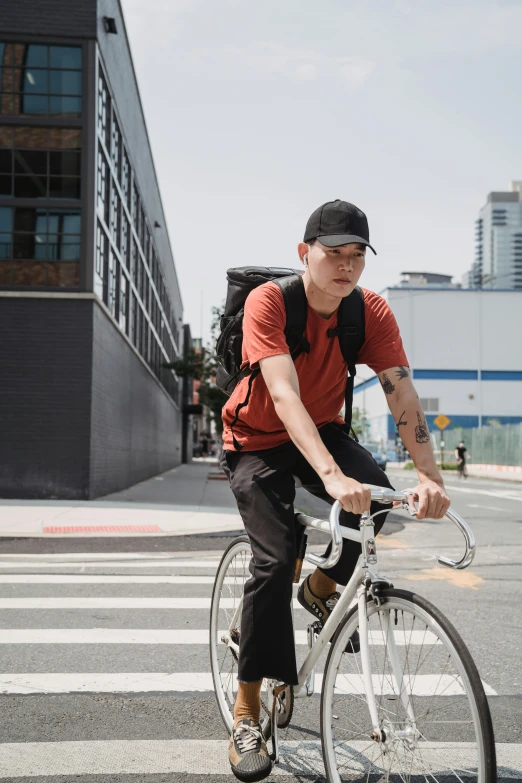 the young man is riding his bike across the street