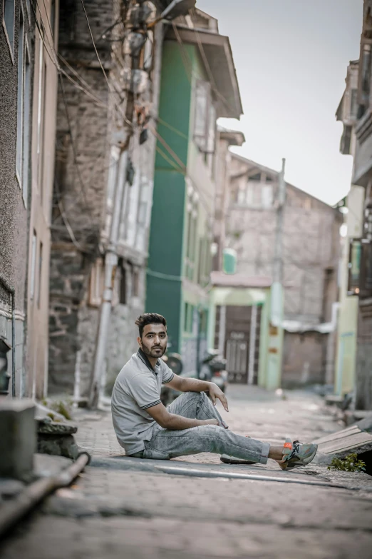 a man that is sitting on the ground