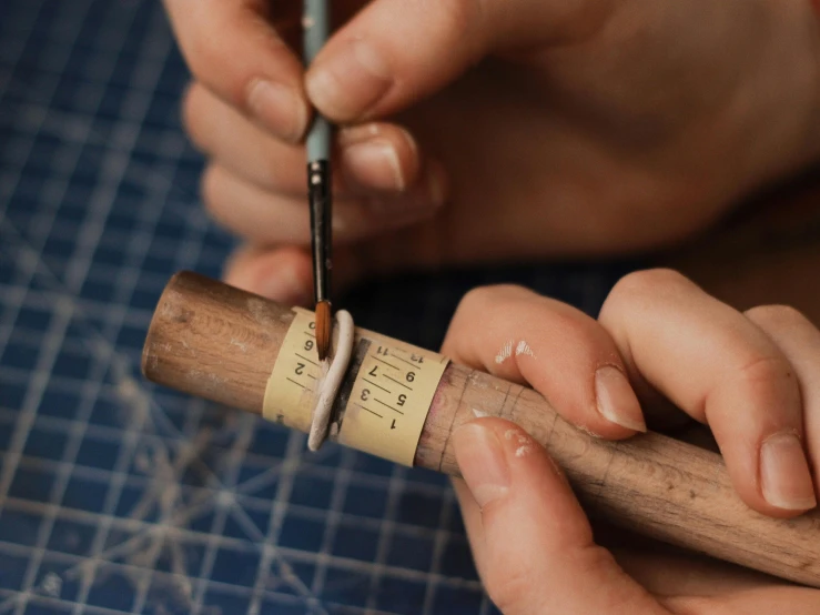 two hands making cigars on top of each other