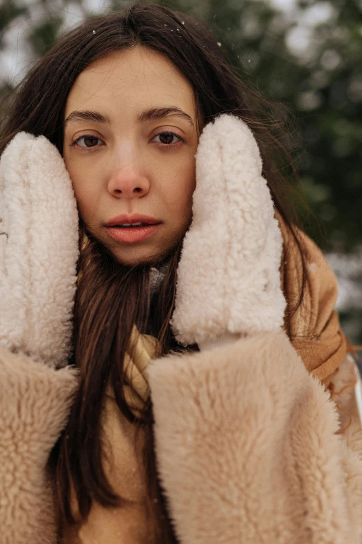 woman covering ears from the cold weather