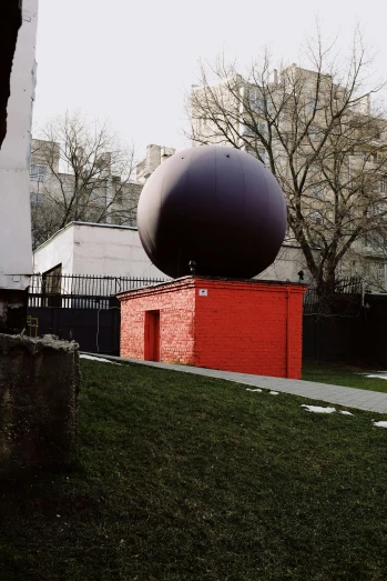 the large object is in front of a tree