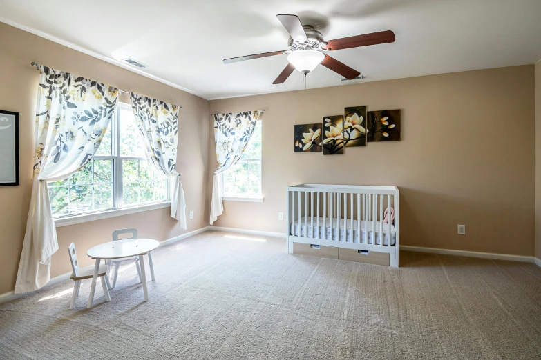 the small white crib has a white chair and table in it