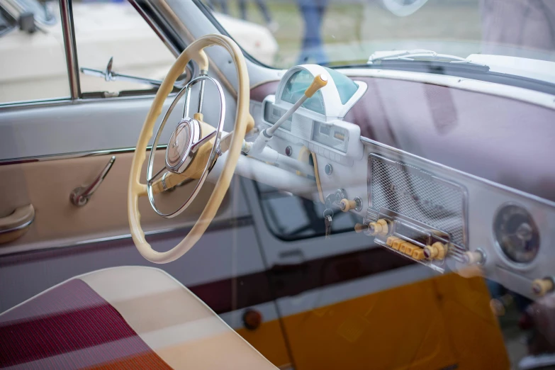 an old car with the steering wheel out