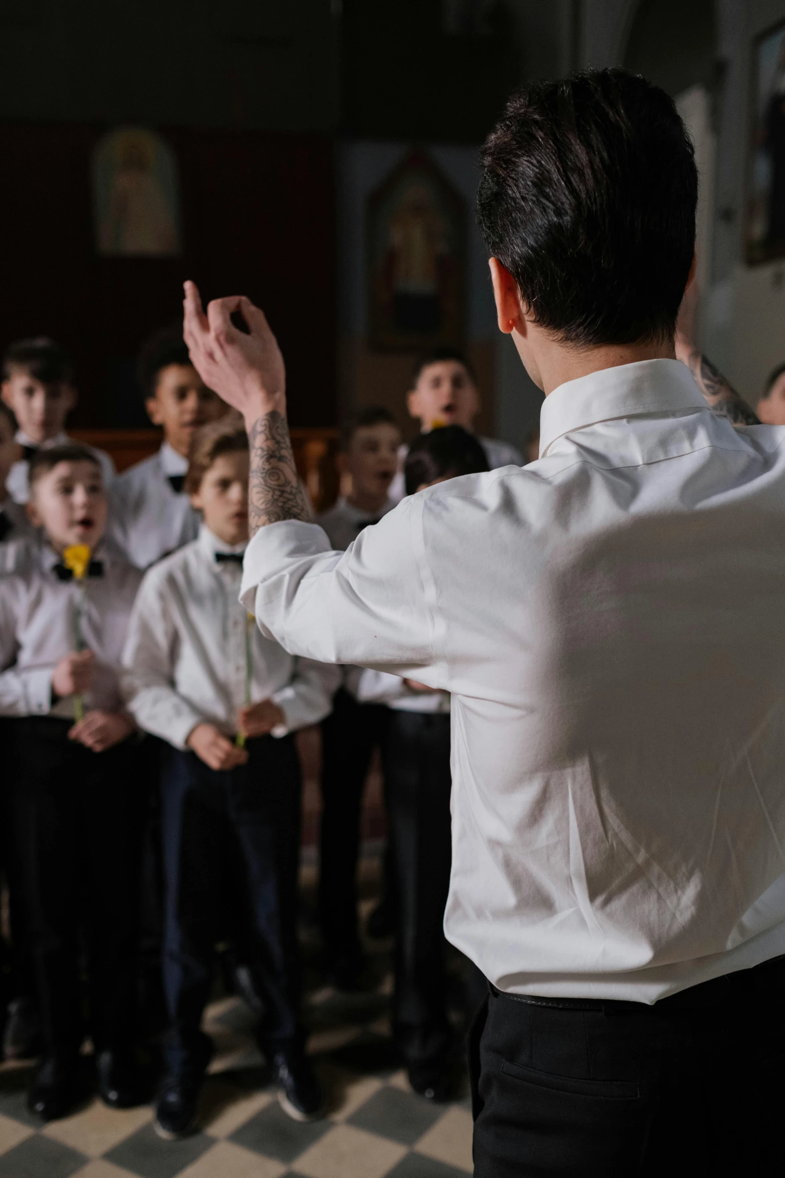 a male choir member stands before an audience