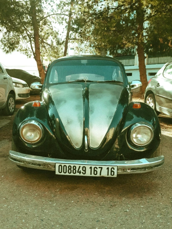 a classic volkswagen beetle is parked in the street