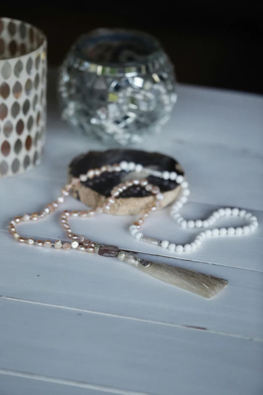 a beads and beaded chain next to a vase