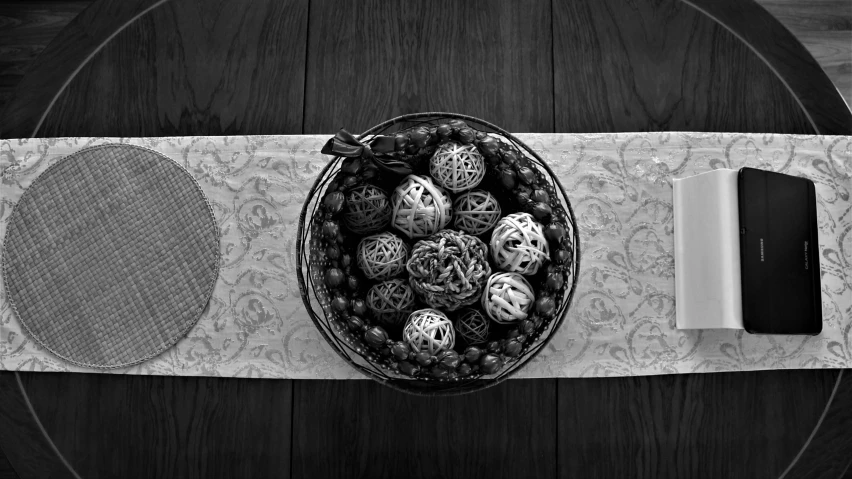 a table topped with a bowl full of different types of eggs