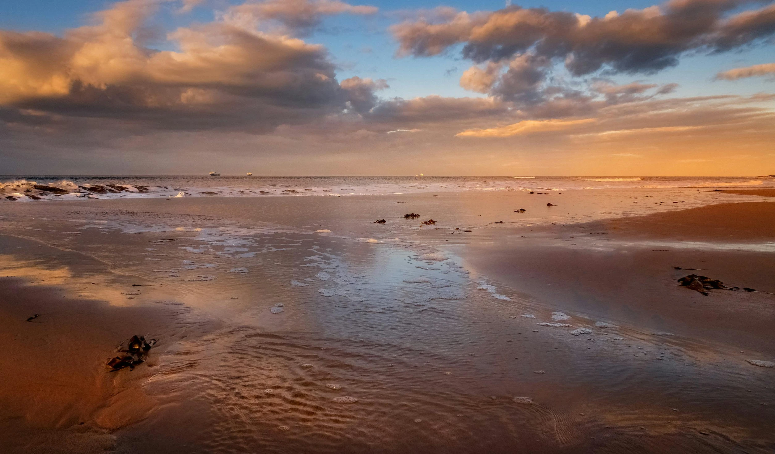 a view of the water and sand at the beach