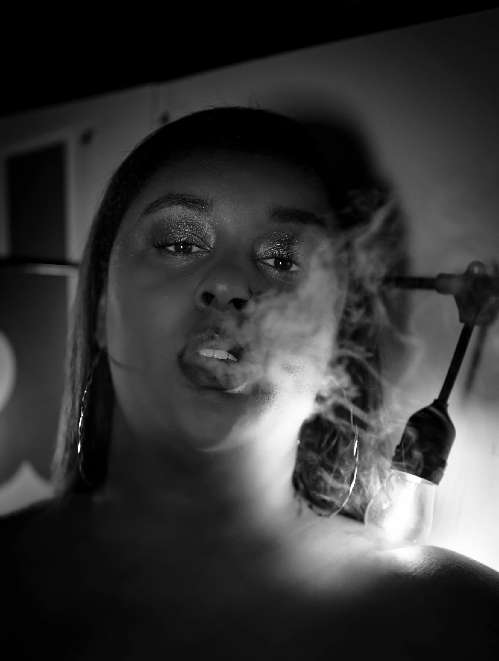 a woman smoking and looking back at the camera