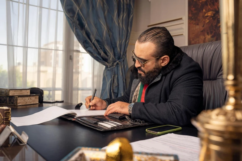 an image of a man writing on his desk