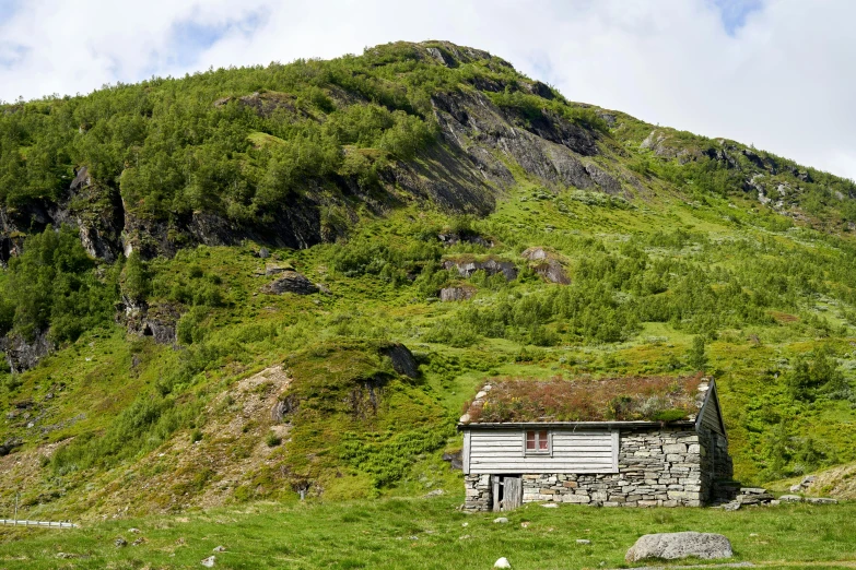 an old, run down shack is in the mountainside