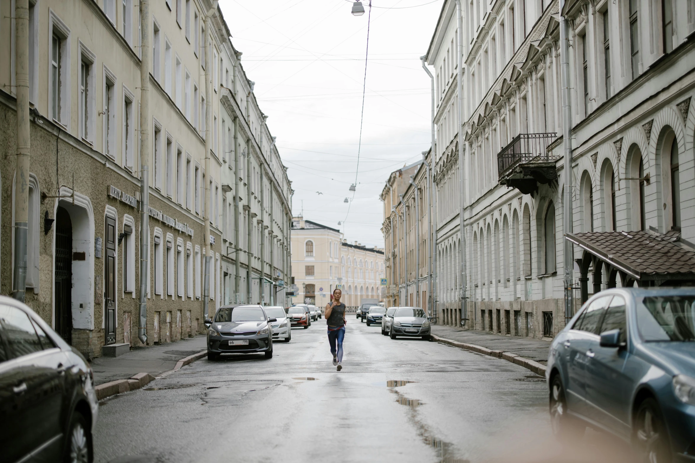 a woman is walking down an empty city street