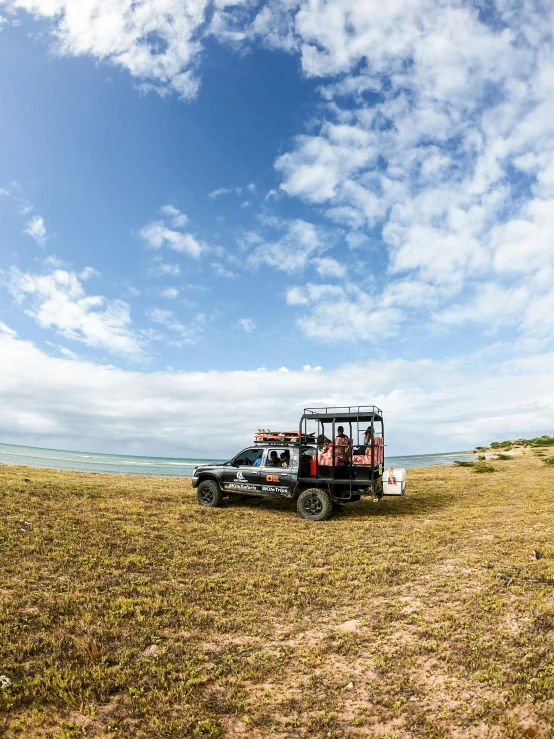 a truck in a field with its roof down