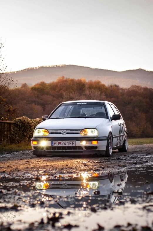 the car is driving in a very wet area