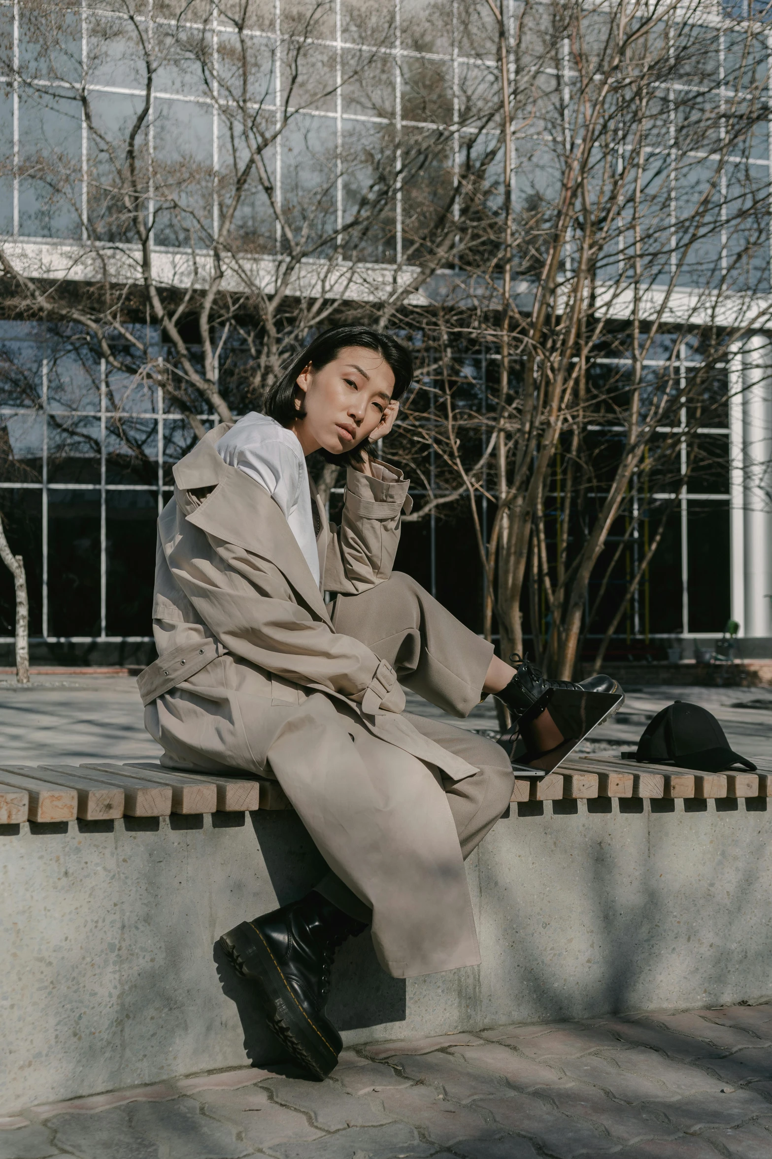 a man sitting on a curb talking on a phone