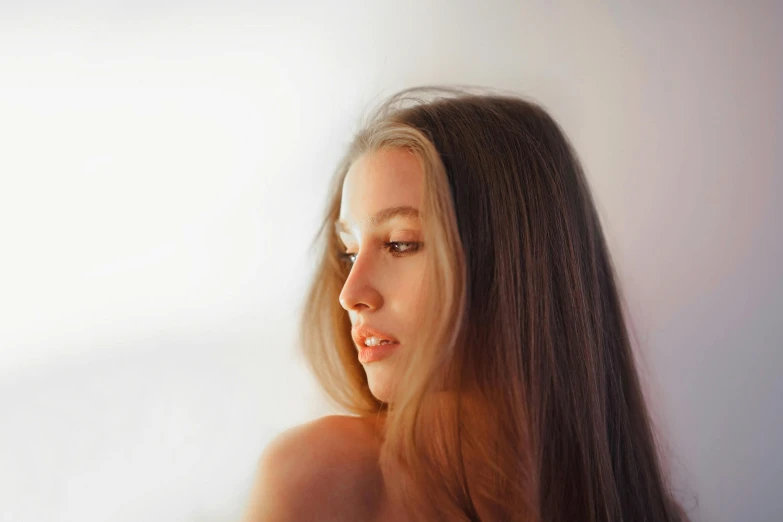 a woman with very long hair standing in front of a white background