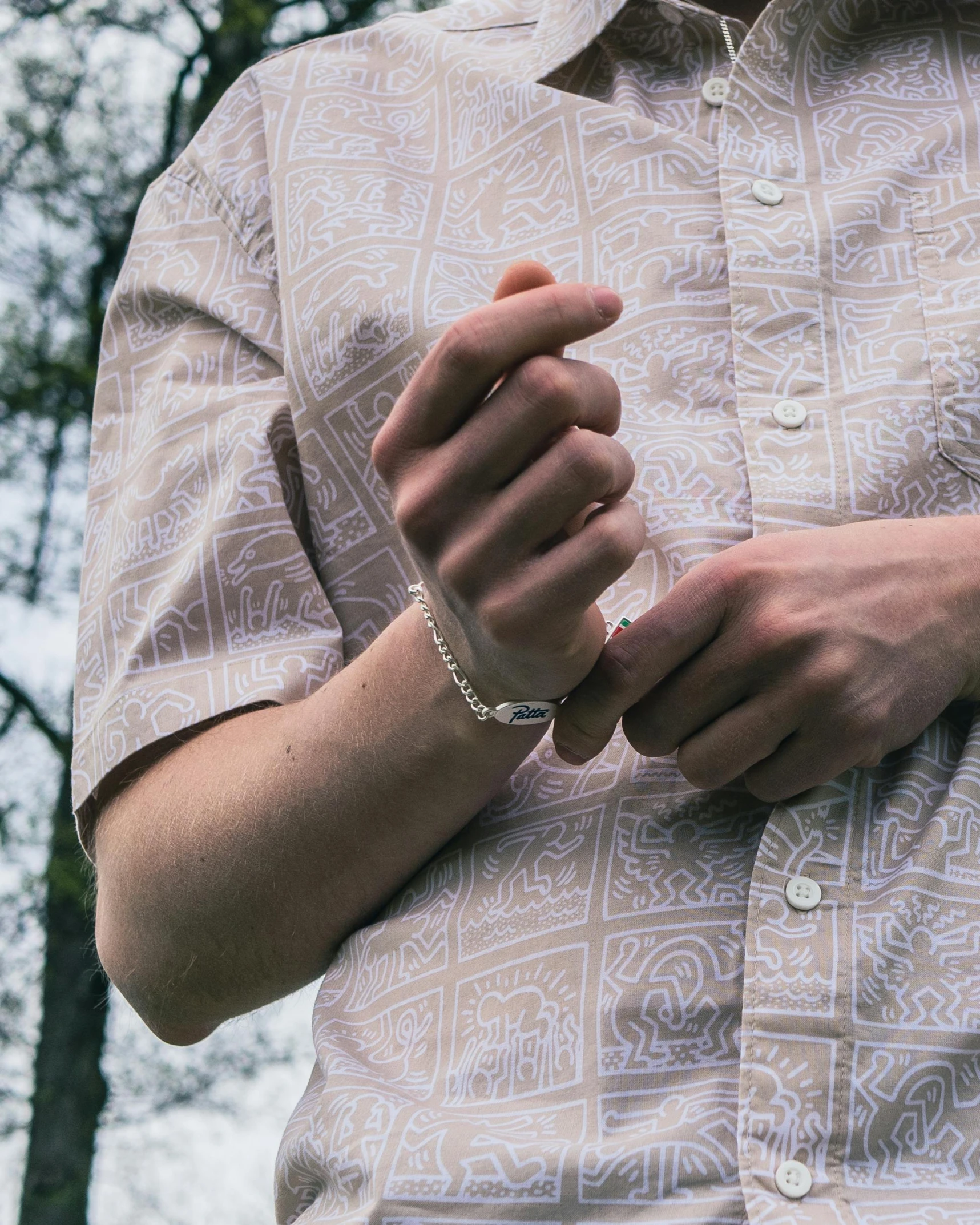 a close up of the hands of a man with a celet