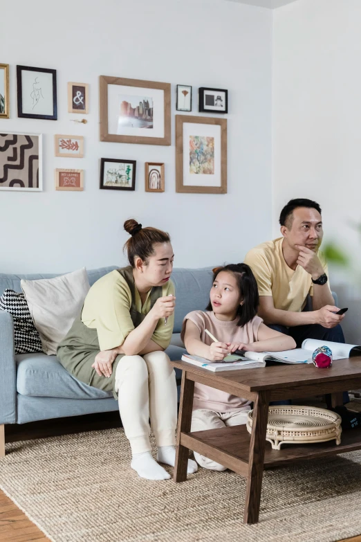 a family is sitting in a living room