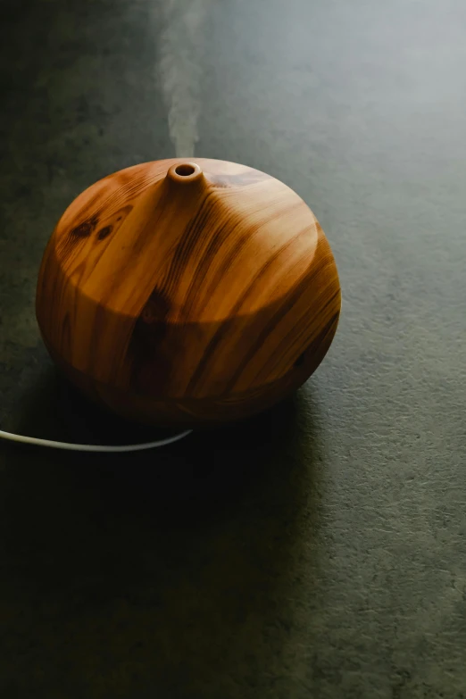 a wooden object on a dark table with light coming through it