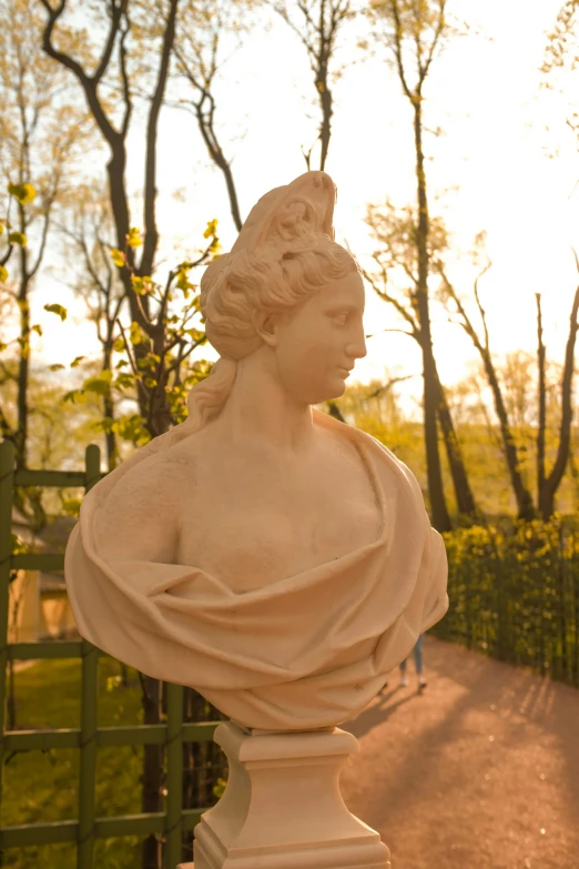 a statue of an unknown woman looks out over the park