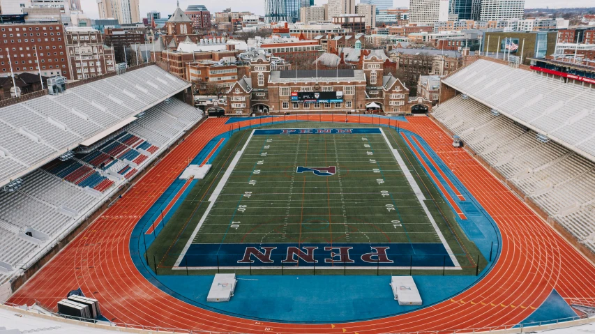 a football field next to large city buildings