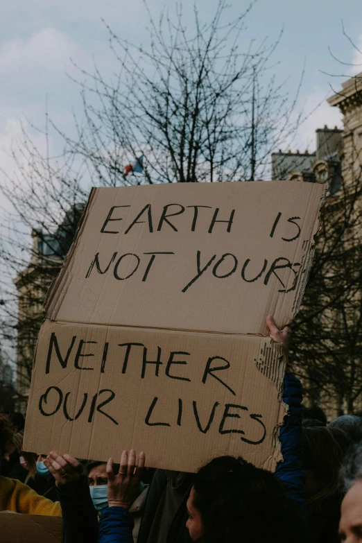 a protestor holds up a sign with words and symbols