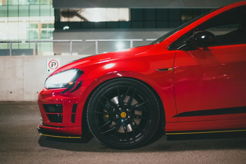 a red sports car sitting in front of a building