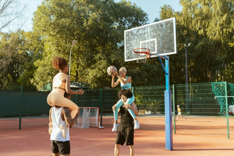 a group of people playing basketball on a court