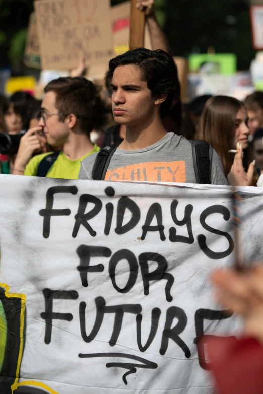 a group of protesters with black writing on a sign