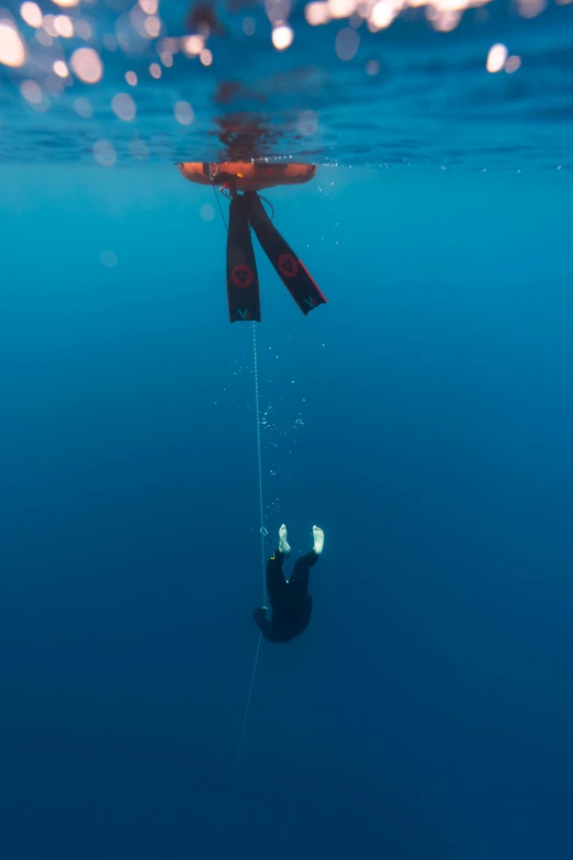 a person hanging on to a rope that's attached to the water