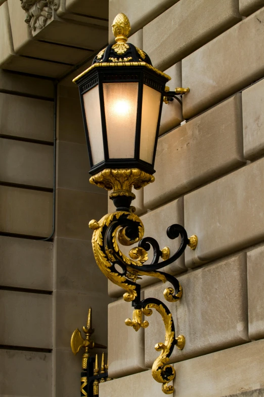 a street lamp next to a wall with a light on it