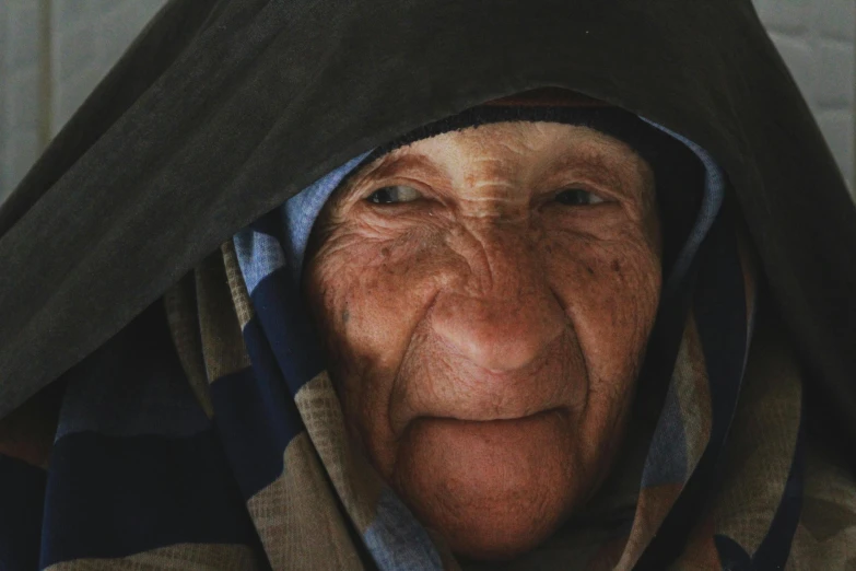 an older woman with a black hoodie has a surprised expression on her face