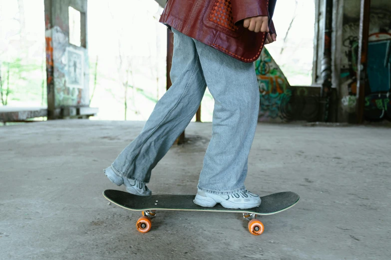 someone with one foot on a skateboard in the middle of a concrete walkway