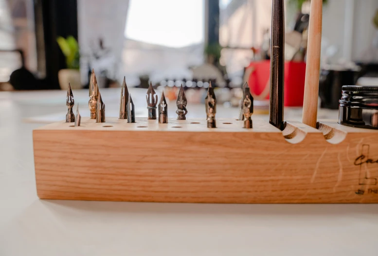 several small screwdrivers are placed on a wooden base