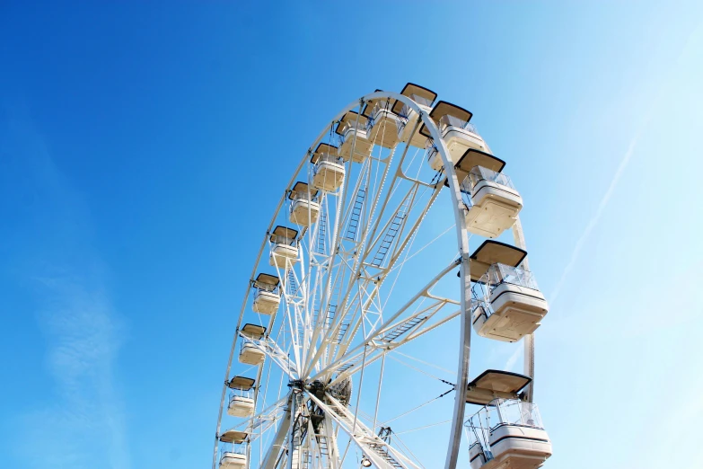 a ferris wheel sitting on the side of a road
