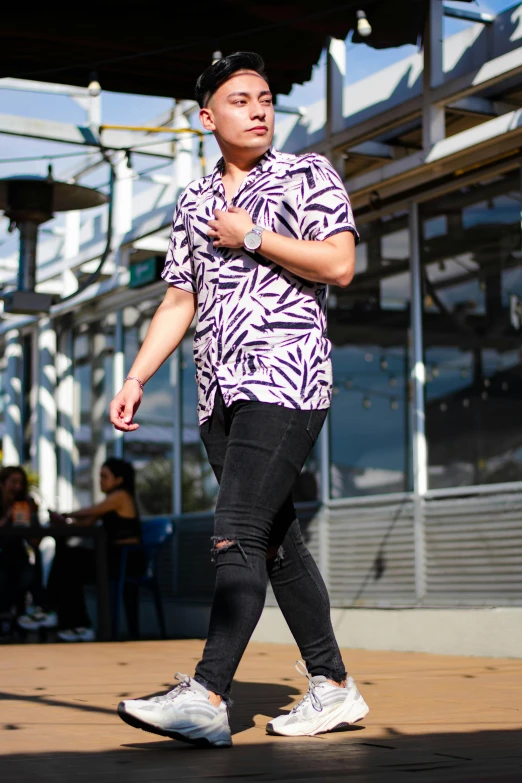 a man in the middle of a sidewalk with a skateboard in hand