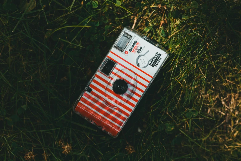 a vintage cell phone laying in the grass