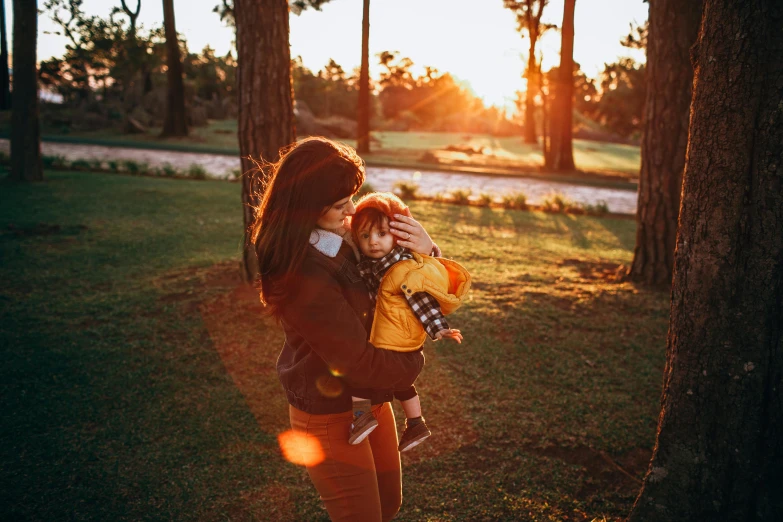 a woman holds a baby and is holding her